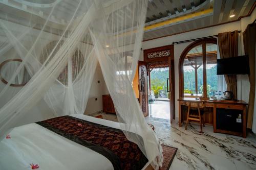 a bedroom with a bed with a mosquito net at Grand Campuhan in Tegalalang