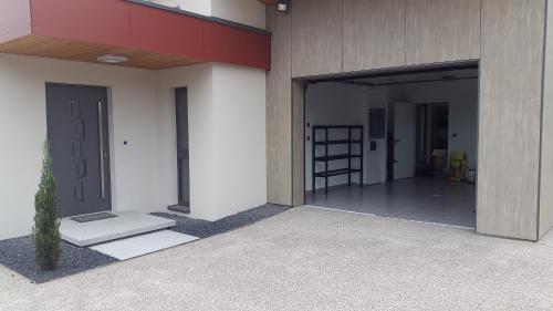 an open door of a building with a ladder in it at Le Gallus in Boersch