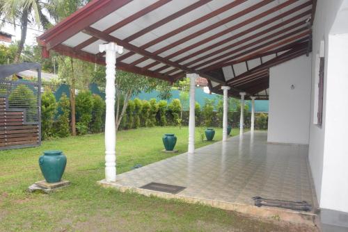 a pavilion with vases sitting under a roof at Grand Breeze Hotel 