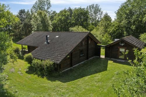 a log cabin in the middle of a yard at Nordic Log Cabin With Views Over The Fields in Hals