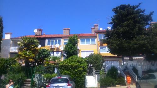 a building with cars parked in front of it at Pipo Apartment Mareda in Novigrad Istria