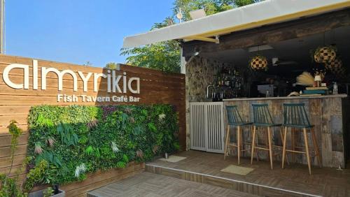 a restaurant with two stools in front of a bar at Grand Beach Hotel Thassos in Limenaria
