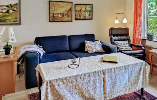 a living room with a blue couch and a table at Holiday Home Stouby 07 in Stouby