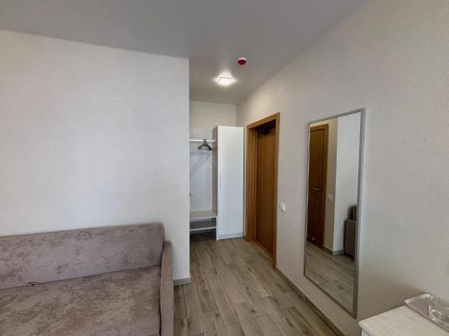 an empty room with white walls and a mirror at Milos Hotel in Zatoka