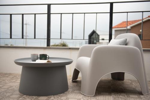 a table and chairs in a room with a large window at Pool Story 6 in Jeju