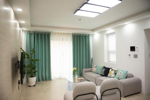 a living room with a couch and a table at Pool Story 6 in Jeju