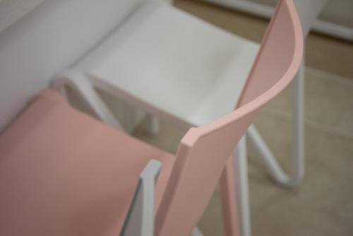 a pink chair sitting next to a table at Pool Story 6 in Jeju