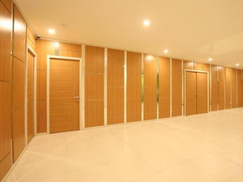 a large walk in closet with wooden doors at Fovere Hotel Palangkaraya in Palangkaraya