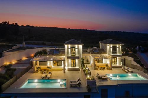 an aerial view of a house with two swimming pools at KALIMERA Luxurious Villas in Lixouri