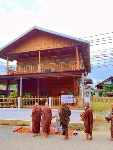 a group of monks standing in front of a building at Le Moon Hotel in Chiang Khan