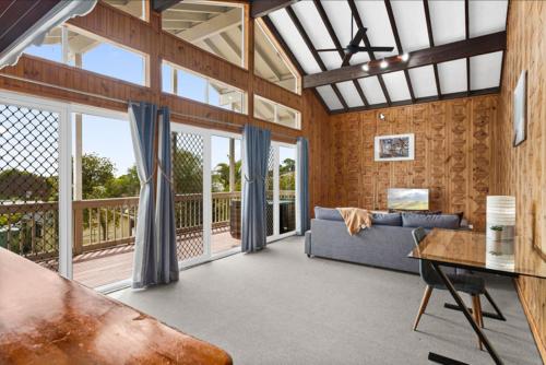 a living room with a couch and a table at Loftus Spacious Getaway in Barrack Point