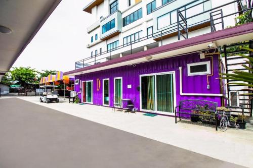 a purple building next to a white building at 5BOX Donmuang Airport in Bangkok