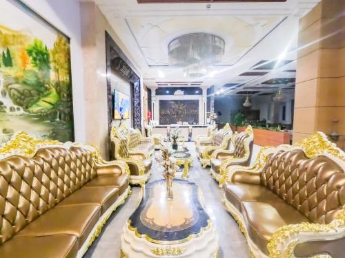 a salon with gold furniture and a fountain in the middle at Royal Palace in Da Lat