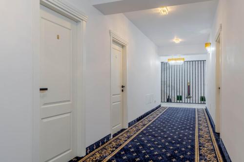a hallway with a door and a tile floor at Hotel Boutique Tunari in Tunari