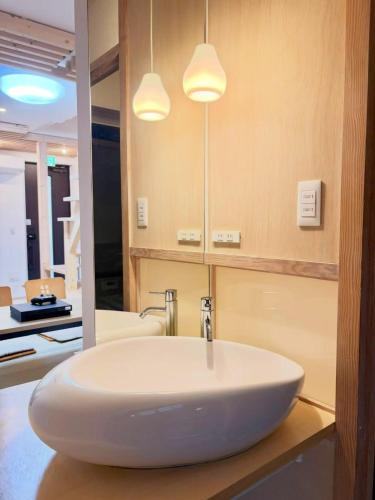 a bathroom with a white sink and a mirror at 東福寺2 都憶 in Kyoto