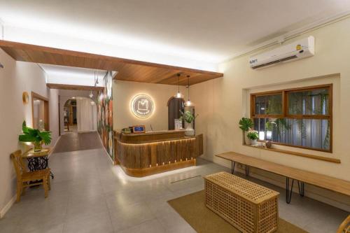 a living room with a lobby with a bar at Need a Nap Hostel Phrae in Phrae