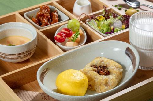 a tray with a bowl of food and bowls of food at private soup holiday villa by the sea in Dapeng