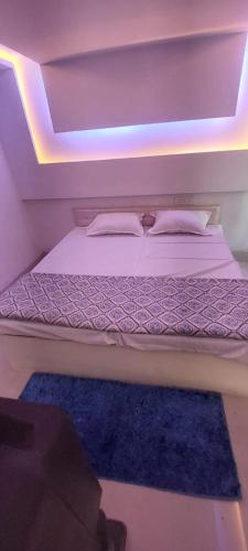 a bedroom with a bed with a blue rug at The Krishnam Resort in Mādho Tānda