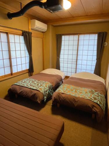 Ein Bett oder Betten in einem Zimmer der Unterkunft Tsukitei1