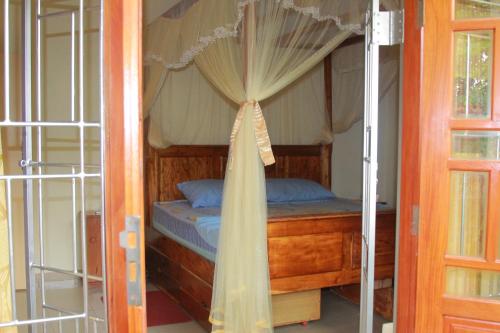 a bedroom with a bed with a canopy at Familyhouse in Negombo