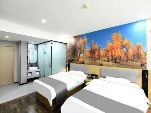 a room with four beds and a painting on the wall at Thank Inn Hotel He'nan Xinxiang Changyuan Bo'ai Road in Changyuan