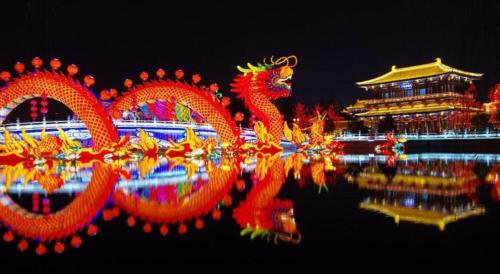 a group of chinese dragons in the water at night at James Joyce Coffetel Xian Dayanta Metro Station Branch in Xi'an