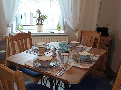 a wooden table with plates and dishes on it at Veronika in Wesenberg
