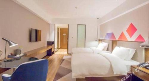 Ένα ή περισσότερα κρεβάτια σε δωμάτιο στο Borrman Hotel Nanning Railway Station