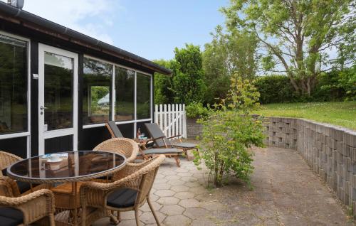 a patio with a table and chairs and a building at Awesome Home In Kirke Såby With Wifi in Kirke Såby