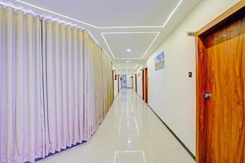 a corridor in a hospital with curtains at FabHotel Royal Manor - Hospital Chowk in Rajkot