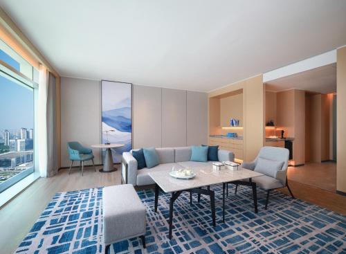 a living room with a couch and a table at Courtyard by Marriott Guangzhou Pazhou in Guangzhou