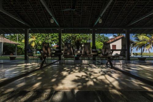 a group of chairs and a table on a patio at The Frangipani Tree by Edwards Collection in Unawatuna