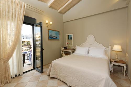 sypialnia z łóżkiem i balkonem w obiekcie Ionia Suites w Retimnie