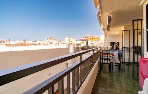 a balcony with a table and chairs on a building at Gorgeous Apartment In Fuengirola in Fuengirola