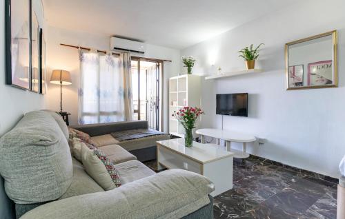 a living room with a couch and a table at Gorgeous Apartment In Fuengirola in Fuengirola
