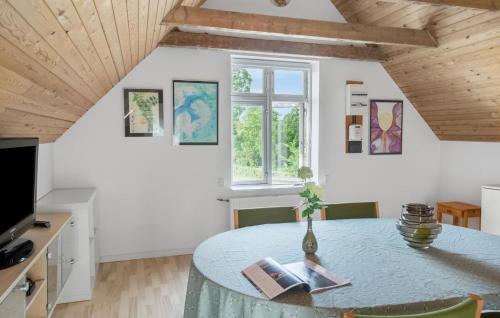 a room with a table with a vase on it at Two-Bedroom Holiday Home In Bogo By in Bogø By