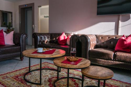 a living room with two tables and a couch at Alpenhotel Ramsauerhof in Ramsau im Zillertal