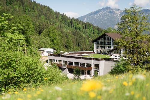 a building in the middle of a mountain at Das Graseck - mountain hideaway & health care in Garmisch-Partenkirchen