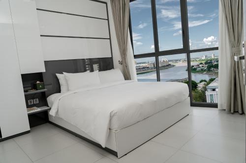 Postel nebo postele na pokoji v ubytování Noden Hotel & Apartment