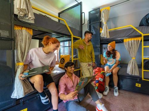 a group of people are sitting in a bus at The Hosteller Mussoorie, Mall Road in Mussoorie