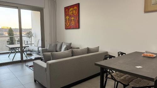 a living room with a couch and a table at Elysia Park Premium in Paphos City