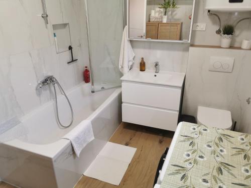 a bathroom with a tub and a sink and a shower at Tonka 1 in Podstrana