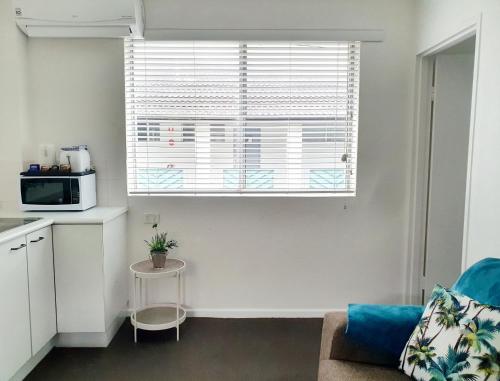 a living room with a couch and a microwave at Oceanside Hawks Nest in Hawks Nest