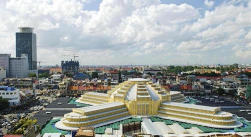 a large yellow and white building in a city at Kirirom Crystal Hotel in Phnom Penh
