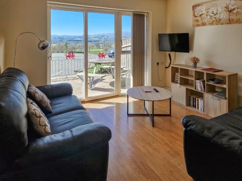 a living room with a couch and a table at Berwyn - Uk48507 in Bala