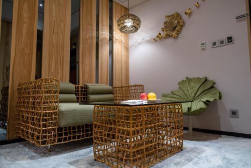 a living room with a couch and a table and chairs at arTree hotel in Taipei