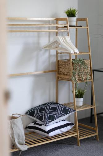 a wooden shelf with plants on it next to a wall at CastleView Haven - Contractors welcome -Strood Rochester sleeps 12 in Strood