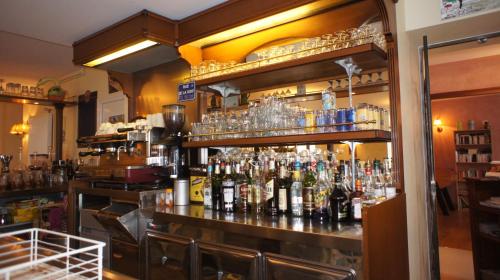 a bar filled with lots of bottles of alcohol at Auberge De Raulhac in Raulhac