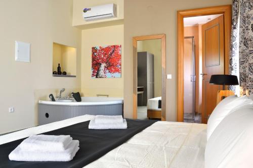 a bedroom with a bed and a bathroom with a sink at Elia Kentron in Chania Town