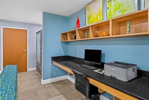a room with a desk with a computer on it at Days Inn by Wyndham Chattanooga/Hamilton Place in Chattanooga